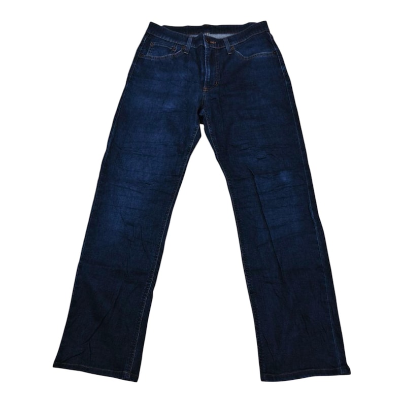 May include: Dark wash denim jeans with a classic five-pocket design. The jeans have a straight leg cut and a button and zipper closure. The denim has a slightly faded appearance.