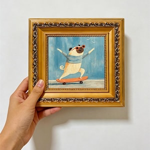 May include: A square oil painting in an ornate gold frame depicting a tan pug wearing red sunglasses and a blue and white striped shirt while riding an orange skateboard against a light blue background with two small white birds in the sky.