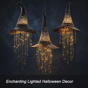 May include: Three black pointed witch hats hanging from above, each featuring a textured surface and a band around the base. Numerous thin, glowing light strands with small gold star accents dangle from the brims, creating a luminous effect.