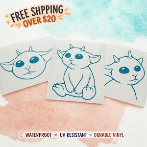 May include: Three white vinyl stickers featuring a teal outline of a cartoon creature with large eyes and small horns. The stickers are waterproof, UV resistant, and made of durable vinyl.