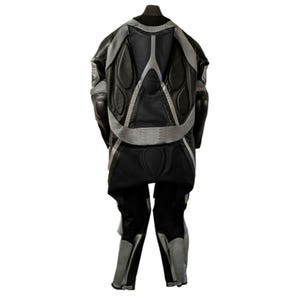 May include: Black and gray motorcycle riding suit. The suit features a padded back and shoulders, with gray accents and panels. The pants and jacket are connected. The suit is designed for protection and safety.