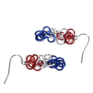 May include: A pair of red, white, and blue chain link earrings with silver hooks.