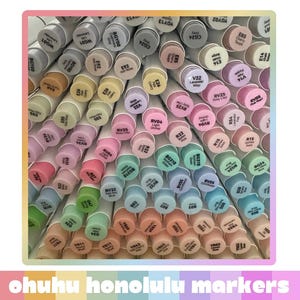 May include: A large collection of Ohuhu Honolulu markers arranged vertically, showing their circular caps in various pastel and vibrant colours. Each cap is labelled with specific colour codes and names, creating a dense, organised grid of art supplies.