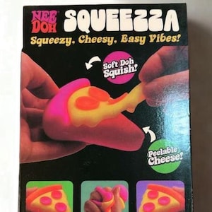 May include: A Nee Doh Squeezza stress reliever toy in a black box. The packaging features text including STRESS RELIEVER, 1pcs, SQUEEZZA, Squeezy, Cheesy, Easy Vibes!, Soft Doh Squish!, and Peelable Cheese! with images of a pizza-shaped squishy toy.