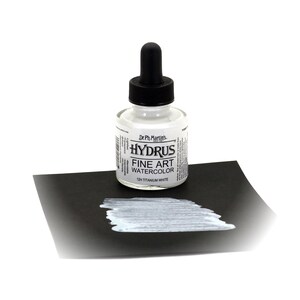 May include: A clear glass bottle of Dr. Ph. Martin's Hydrus Fine Art Watercolor in 12H Titanium White. The bottle has a black dropper cap and is sitting on a black surface. A white paint swatch is on the surface.