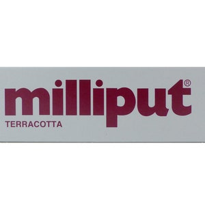 May include: A white label with the text "milliput®" in burgundy lettering and the word "TERRACOTTA" in smaller burgundy lettering below.