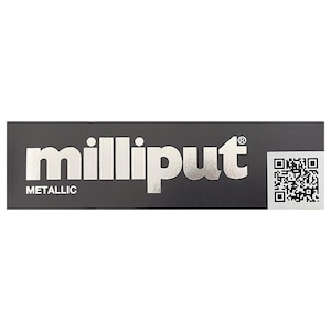May include: A black rectangular package with the word "milliput" in metallic silver lettering. The word "METALLIC" is printed below the main text. A QR code is on the right side of the package.