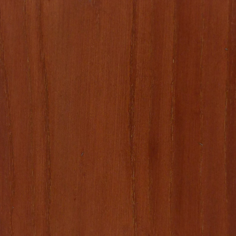 May include: Close-up of a wood grain pattern. The wood has a reddish-brown color with vertical grain lines. The surface appears smooth and polished, with subtle variations in tone and texture.