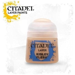 May include: A bottle of Citadel Layer Paints in Kislev Flesh colour. The bottle is beige with a white cap and a blue label. The Citadel logo and the words "Layer Paints" are visible at the top. The text "Kislev Flesh" is on the label.
