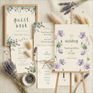 May include: Wedding stationery set featuring a guest book, save-the-date cards, menu, and welcome sign. The designs include lavender and purple floral accents. The wedding sign is on a wooden easel. The text includes the names Samantha & Evan.