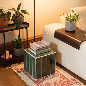 May include: A rustic wooden sign with the text "Welcome to our home" in white lettering. The sign features a distressed finish and a simple, inviting design, perfect for a front porch or entryway.