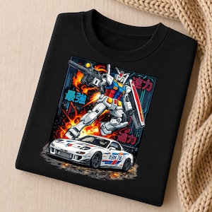 May include: A black crewneck sweatshirt featuring a graphic print of a white sports car with blue and red racing stripes and the text RK 78, positioned below a large white, blue, and red robot holding a rifle amidst orange flames and blue text.