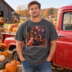May include: A charcoal gray short-sleeve t-shirt featuring a graphic print of cats dressed in Halloween costumes. The design includes text that reads "Memories by Cheryl" and "Trick or Treat" with cats holding pumpkins in a festive scene.