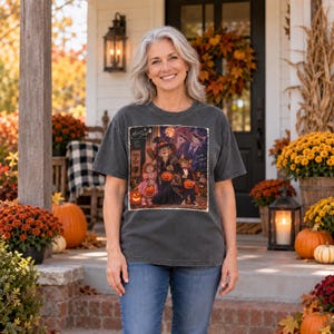May include: A charcoal gray short-sleeve t-shirt featuring a graphic print of cats dressed in Halloween costumes, including a witch and a vampire, holding jack-o'-lanterns. The print includes the text "Trick or Treat" and "Memories by Cheryl".