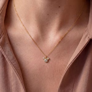 May include: A set of three ceramic mugs with a speckled, matte finish. The mugs are in cream, light grey, and dark grey. Each mug has a simple, minimalist design, ideal for coffee or tea.