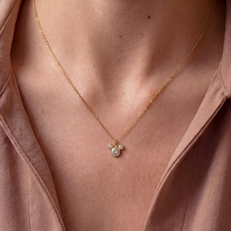 May include: A set of three ceramic mugs with a speckled, matte finish. The mugs are in cream, light grey, and dark grey. Each mug has a simple, minimalist design, ideal for coffee or tea.