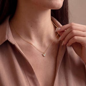 May include: A white ceramic mug with a black handle and the text "But First, Coffee" in a bold, black font. The mug is on a wooden surface. The mug appears to hold approximately 355 ml.