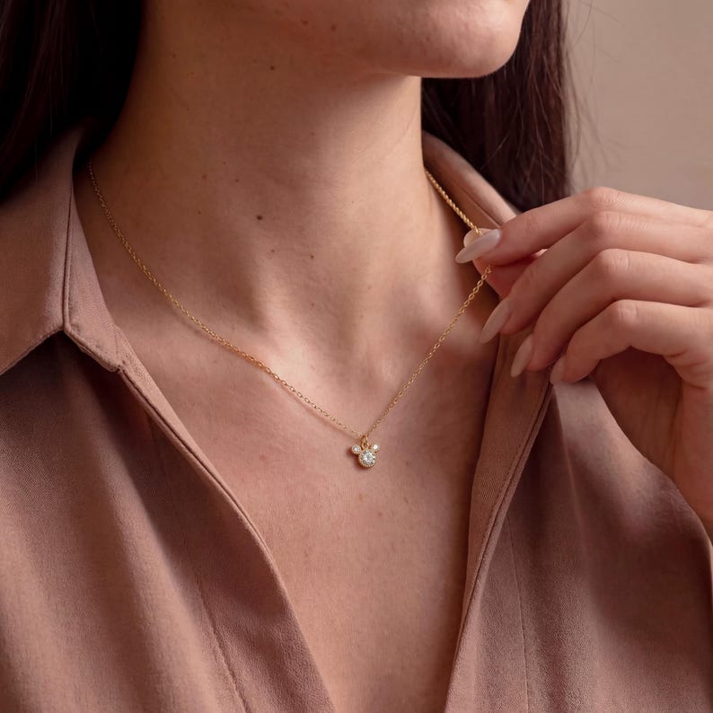 May include: A white ceramic mug with a black handle and the text "But First, Coffee" in a bold, black font. The mug is on a wooden surface. The mug appears to hold approximately 355 ml.