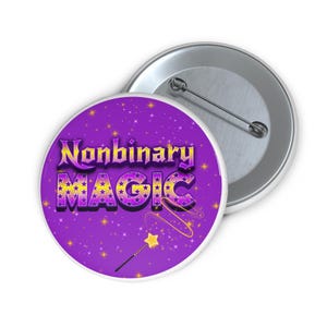 May include: A round, purple button with the words "Nonbinary MAGIC" in yellow and purple, decorated with stars. A small magic wand with a star tip is also featured. A second, silver button back is visible.