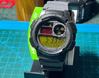 Casio AE-1000 digital watch customized with a modified radiation/nuclear screen.