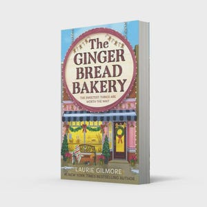 May include: A book titled The Ginger Bread Bakery by Laurie Gilmore. The cover features a storefront with a large circular sign, blue and white striped awning, green wreaths, and a bench. The text reads The Ginger Bread Bakery The Sweetest Things Are Worth The Wait.
