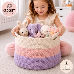 May include: A round, crochet storage basket in cream, pink, and purple holds several crochet stuffed animals, including a bunny, elephant, star, and flower. The basket has handles and is labeled "CROCHET PATTERN" and "PDF DOWNLOAD".