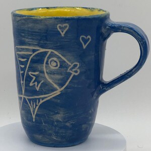 Fish love mug!  Fishies swimming in a blue outside with a yellow interior.