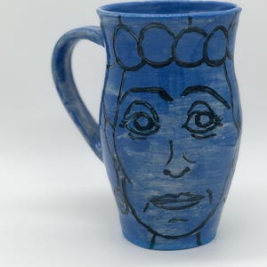 Lady with fancy bubble hat and earrings mug