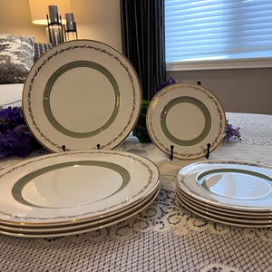 May include: A set of three ceramic nesting bowls in shades of blue, green, and white. The bowls feature a speckled glaze and a simple, modern design. The largest bowl is approximately 7 inches in diameter.
