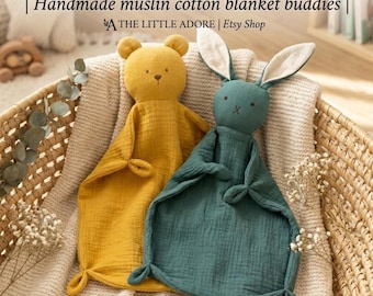 May include: Two muslin cotton loveies featuring a mustard yellow bear and a dark teal rabbit with long ears. Both toys have embroidered facial features and knotted corners. The text reads: SNUGGLE-SOFT LOVEIES | Handmade muslin cotton blanket buddies | THE LITTLE ADORE | Etsy Shop.