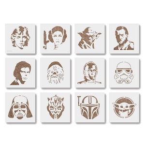 May include: A collection of twelve square stencils featuring iconic characters from the Star Wars franchise. The stencils are in a brown color and include portraits of Luke Skywalker, Princess Leia, Yoda, Darth Vader, and others. The stencils are arranged in a grid.