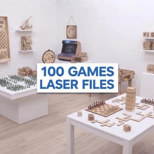 May include: A collection of laser-cut wooden board games and puzzles displayed on white tables and shelves, featuring a wall-mounted game board with the text "CAP OFF" and "GAME ON," and a central overlay with the text "100 GAMES LASER FILES."