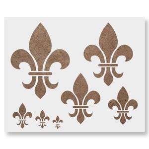 May include: A collection of brown fleur-de-lis stencils in various sizes, arranged on a white background. The stencils feature the classic three-petal design, ideal for crafting and decorative projects.