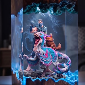 May include: A unique resin art piece featuring a warrior figure, a colorful dinosaur, and a small cat. The artwork is encased in a rectangular block with a wood-like top and bottom, and blue glowing accents.