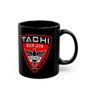 May include: A black ceramic mug featuring a red shield-shaped emblem on the front. The emblem displays the white text TACHI, ECF-270, and MCRN, along with a black eagle graphic and the Chinese characters 首次作战 centred within the shield design.