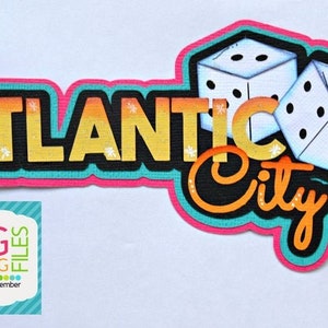 May include: A layered design featuring the words "ATLANTIC City" in yellow and orange, with two dice. The design has a black outline with a pink and teal border. The image also includes a logo for "SVG CUTTING FILES".