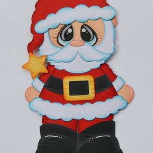 May include: A paper craft cutout of Santa Claus with a red hat, white beard, and a black belt with a yellow buckle. He is holding a yellow star in his left hand.
