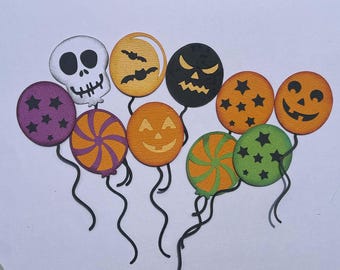 May include: A collection of ten die-cut paper decorations shaped like balloons, featuring Halloween themes including a white skull, orange jack-o'-lanterns, black bats, purple and green stars, and colorful swirl patterns, each with a black paper string.
