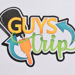 May include: A black, green, blue, and orange graphic with the text "GUYS TRIP" and a stylized key with an arrow pointing to the right.