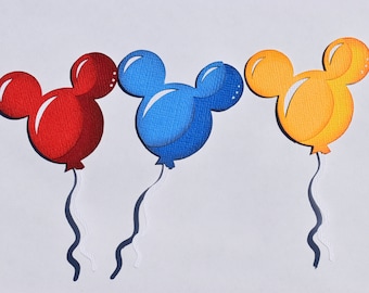 May include: Three Mickey Mouse shaped balloons in red, blue, and yellow. The balloons are cut out of paper and have a white string attached to each.