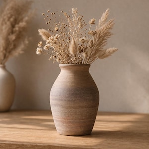 May include: A set of three ceramic mugs with a speckled, matte finish. Each mug features a different color: light blue, cream, and gray. The mugs have a simple, modern design and a comfortable handle.