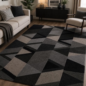 May include: A geometric patterned rug in shades of black, grey, and tan. The rug has a modern design with angular shapes and varying textures. This floor covering adds a contemporary touch to any living space.