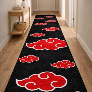 May include: Black hallway runner rug with a repeating pattern of red clouds outlined in white. The rug is rectangular and designed for a hallway or entryway. The cloud design is repeated across the length of the rug.