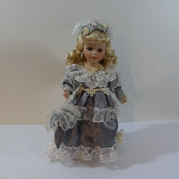 Blonde-Haired Girl 10.5" Porcelain Doll in Victorian Dress holding Parasol with Stand