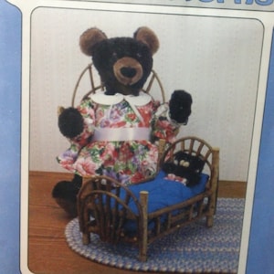 May include: A blue package featuring a bear pattern. The package has the text "POLY-FIL Poly-Patterns" and "MAMA BEAR & BABY BERT". The image shows a black bear wearing a floral dress and a baby bear in a wooden bed. The package is in a clear plastic bag.