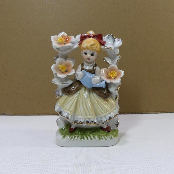 Vintage Porcelain Girl with Black Eyes Holding Watering Can with Floral Archway Figurine