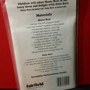 May include: A clear plastic package containing a sewing pattern for a Mama Bear and Baby Bert stuffed animal. The package lists the materials needed, including fabric, fiberfill, and ribbon. The text indicates Mama Bear is 23 inches tall and Baby Bert is 6 inches tall.