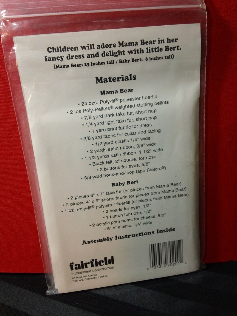 May include: A clear plastic package containing a sewing pattern for a Mama Bear and Baby Bert stuffed animal. The package lists the materials needed, including fabric, fiberfill, and ribbon. The text indicates Mama Bear is 23 inches tall and Baby Bert is 6 inches tall.