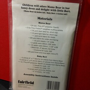 May include: A clear plastic bag containing a sewing pattern for a Mama Bear and Baby Bert plush toy. The text on the pattern lists materials needed, including fabric, fiberfill, and notions. Mama Bear is 23 inches tall, Baby Bert is 6 inches tall.