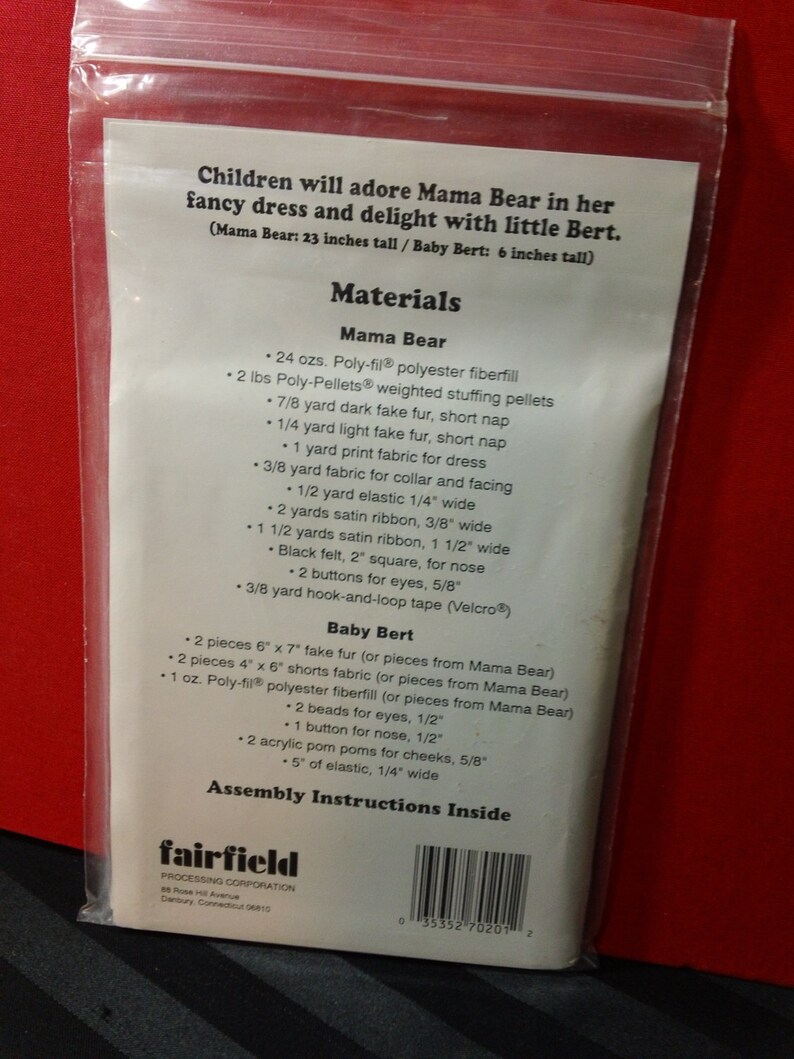 May include: A clear plastic bag containing a sewing pattern for a Mama Bear and Baby Bert plush toy. The text on the pattern lists materials needed, including fabric, fiberfill, and notions. Mama Bear is 23 inches tall, Baby Bert is 6 inches tall.